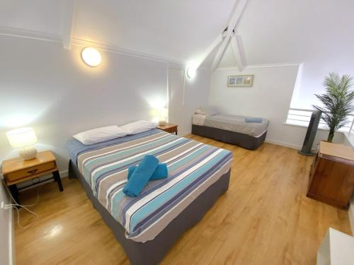 a bedroom with a bed with blue pillows on it at Osprey Holiday Village Unit 109 in Exmouth