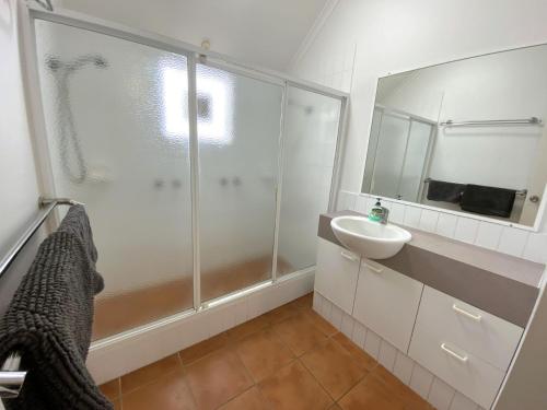 a bathroom with a shower and a sink at Osprey Holiday Village Unit 109 in Exmouth
