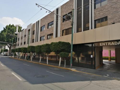 an empty street in front of a building at Hotel Moctezuma La Villa in Mexico City