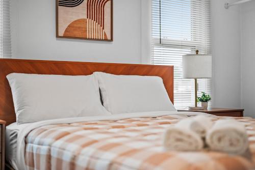 a bedroom with a bed with a striped comforter at Slick&Spacious 2 Bdr Apt Natrona Hts in Natrona Heights