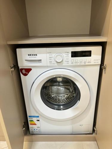 a white washing machine in a room at 1 комнатная, уютная квартира в новом ЖК in Kostanay