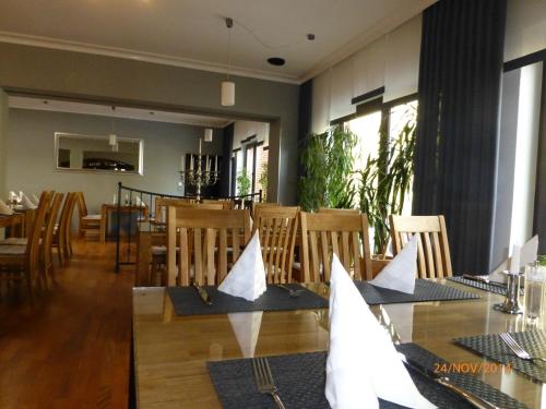 a dining room with a table and chairs at Hotel Rüstersieler Hof in Wilhelmshaven