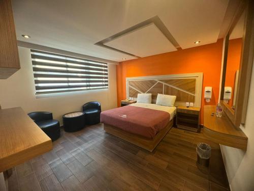 a hotel room with a bed and a window at Hotel Moctezuma La Villa in Mexico City