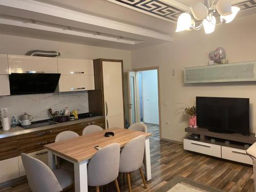a kitchen and dining room with a table and chairs at Tirana Perla in Sauk