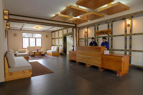 two men in a salon with a waiting room at Willing Resort, Trongsa in Kagha