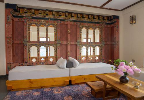 a bed in a room with a large window at Willing Resort, Trongsa in Kagha