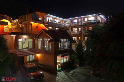 a building with a car parked in front of it at night at Hotel Melungtse & Apartment in Kathmandu