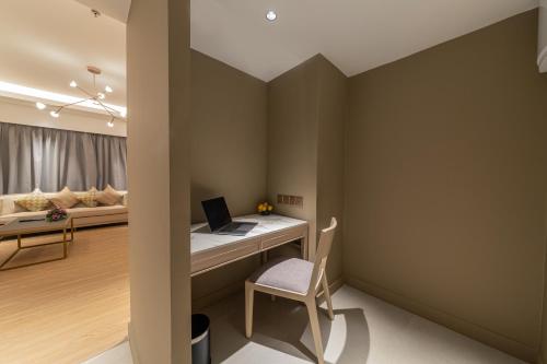 a room with a desk with a laptop on it at Glenmarie Hotel and Golf Resort in Shah Alam