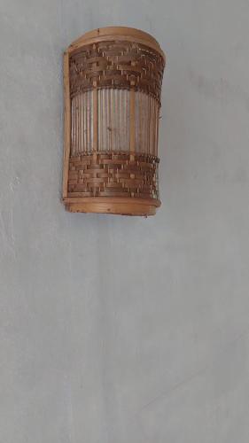 a wooden chandelier hanging from a ceiling at Arnata Guest House & Pasraman Yoga Lokanata in Bangli