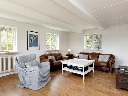 a living room with couches and a coffee table at 6 person holiday home in Store Heddinge-By Traum in Store Heddinge