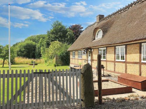 a wooden fence in front of a brick house at 6 person holiday home in Store Heddinge-By Traum in Store Heddinge