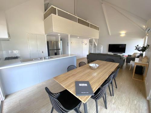 a dining room and kitchen with a table and chairs at Osprey Holiday Village Unit 106 in Exmouth