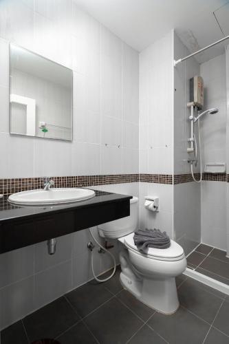a bathroom with a toilet and a sink and a mirror at Nice to meat you Rooms in Patong Beach