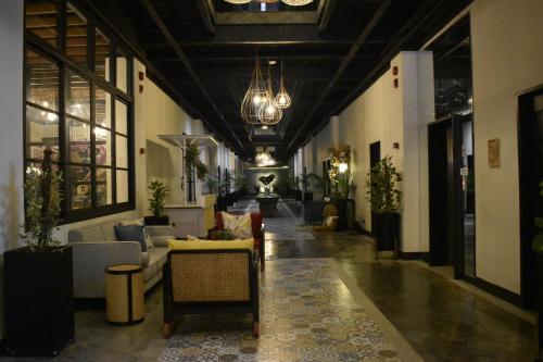 a living room with couches and chairs in a building at Patio by Balai Norte in San Juan