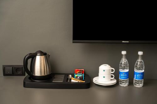 a counter with two bottles of water and a kettle at Kefilyan Family Hotel in Haghpat