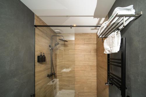 a shower with a glass door in a bathroom at Kefilyan Family Hotel in Haghpat