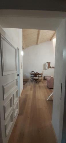 an empty living room with a table and a door at Casa di legno in Città di Castello