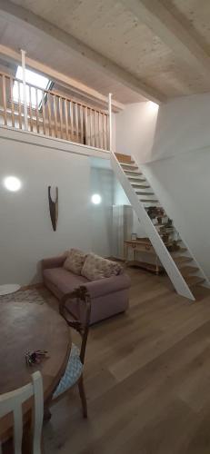 a living room with a couch and a staircase at Casa di legno in Città di Castello