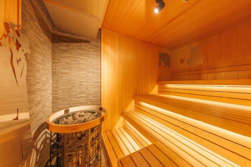 a wooden sauna with a tub in it at Fujisan Ryokan in Hanamaki
