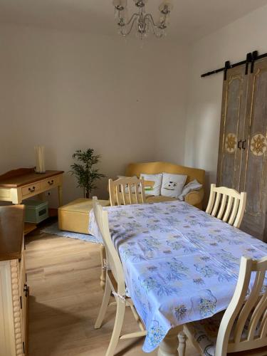 a dining room with a table and chairs and a chandelier at Casa di legno in Città di Castello