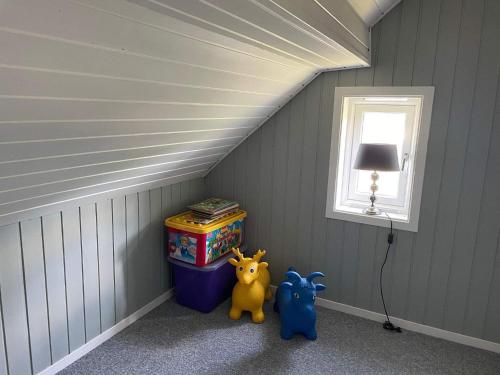 a corner of a room with two toys in a attic at 6 person holiday home in BØMLO in Bømlo