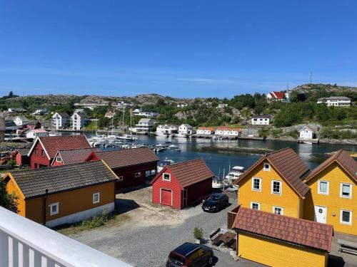 a view of a town with a river and houses at 6 person holiday home in BØMLO in Bømlo