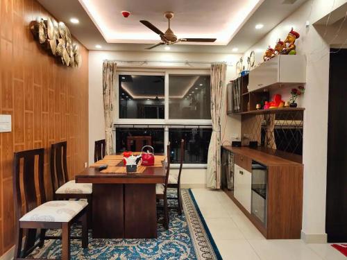 a kitchen with a table and a ceiling fan at Elite 3BHK- 19th Floor Only for Family in Bengaluru