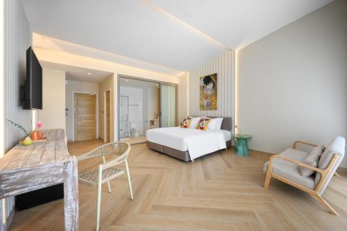a bedroom with a bed and a table and chairs at Centara Life Lamai Resort Samui in Lamai