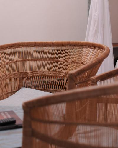 two wicker chairs sitting next to a table at The Waterfront, Maun in Maun