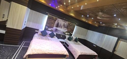 a room with two beds and a window in it at Anyhour Stay in Gannavaram