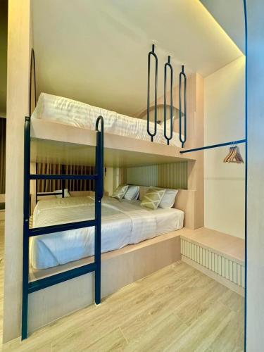 a bedroom with two bunk beds in a room at The Present Samed pool villa in Ko Samed