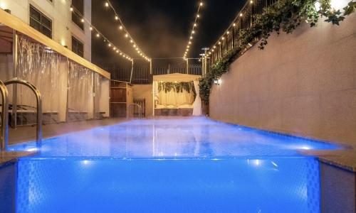 a large blue swimming pool in a building at Daegu February Hotel Dongseongro in Daegu