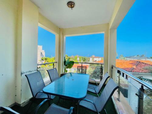 a balcony with a blue table and chairs at Elna's Nyali - Work & Unwind - Pool, Sea Views, AC & Fast Wi-Fi in Mombasa
