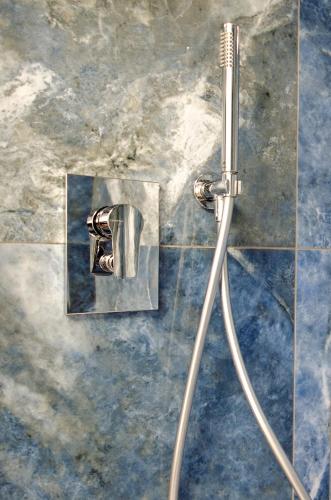 a shower in a bathroom with a shower head at Hotel Palace del Conero in Osimo