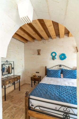 a bedroom with a bed and a wooden ceiling at ASTARTE HOTEL in Urfa