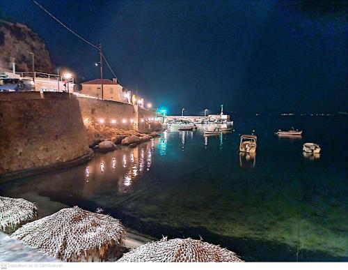 a harbor at night with boats in the water at Elea rooms 7 in Elia Laconias