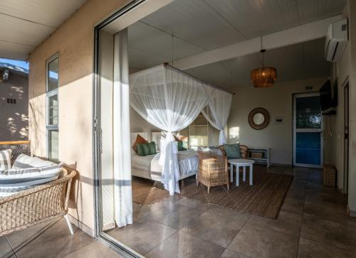 a living room with a couch and a bed at The Waterfront, Maun in Maun