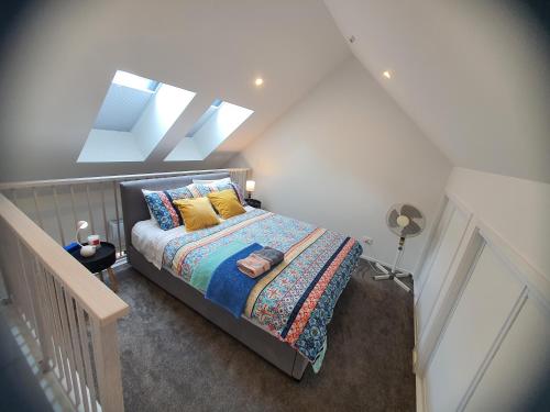 a bedroom with a bed and a skylight at Modern Loft in Christchurch CBD with Private Courtyard in Christchurch