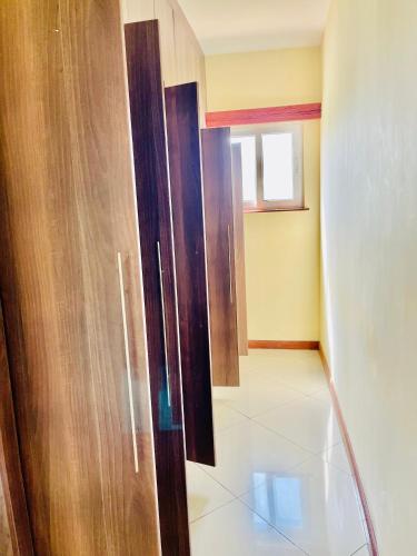 a room with a wooden door and a window at Elna's Nyali - Work & Unwind - Pool, Sea Views, AC & Fast Wi-Fi in Mombasa