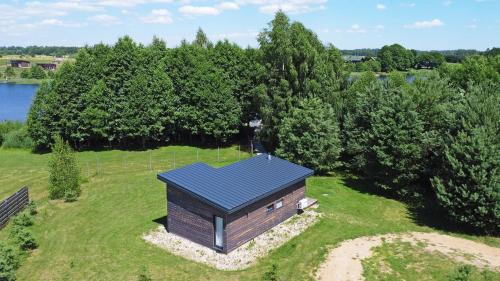 an overhead view of a small building on a field at Pineplace in Joniškis