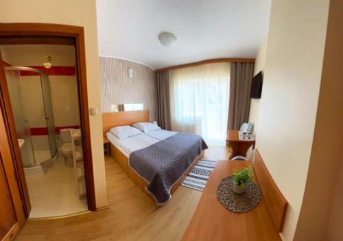 a hotel room with a bed and a bathroom at Willa Balticus in Władysławowo