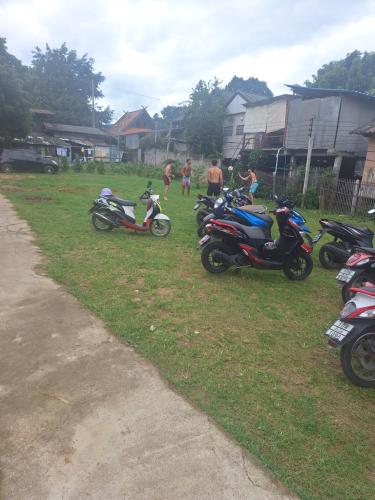 a group of motorcycles parked in the grass at Sleep Pai Bed & Breakfast in Pai