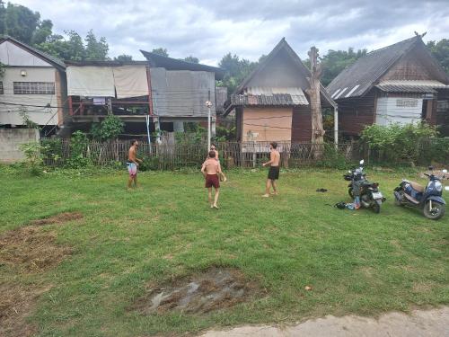 a group of people standing in a yard at Sleep Pai Bed & Breakfast in Pai