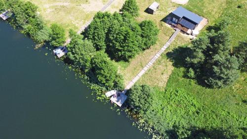 an aerial view of a house next to a river at Pineplace trio KOPA in Žaugėdai