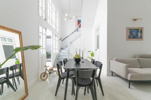 a dining room with a table and a couch at 1924 Gemini House Jacuzzi, Garden, Rooftop in Nicosia