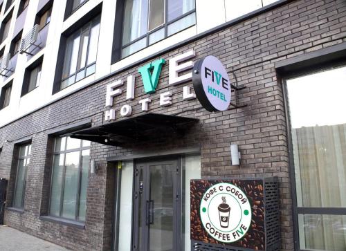 a brick building with a sign for a coffee shop at Five's Hotel Astana in Astana