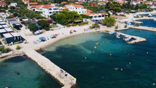an aerial view of a beach with people in the water at Mobile Home Sea Breeze in Sveti Petar