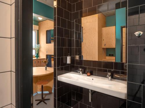 a bathroom with a sink and a mirror at Eklo Montpellier Centre Gare in Montpellier