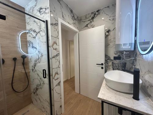 a bathroom with a sink and a shower at Apartment San Pietro in Supetar