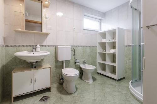a bathroom with a toilet and a sink at Apartments Leonid in Podčetrtek